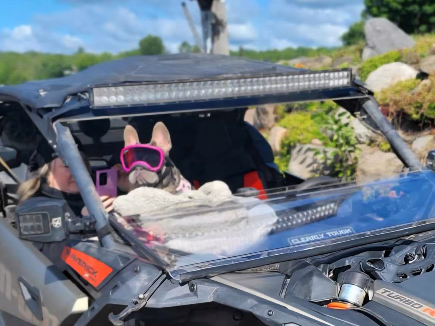 Xena in her pink goggles riding in the side-by-side